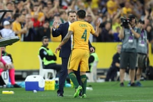 Cahill is embraced by coach Postecoglou as he is substituted on the hour-mark.