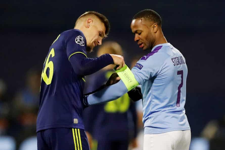 Respect: Emir Dilaver helps Raheem Sterling with his arm band.