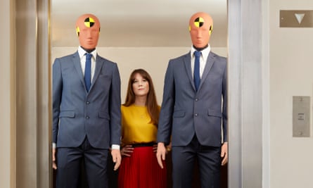 A woman between two male crash test dummies
