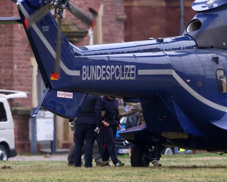 Police escorts Serhii K. to a helicopter following a hearing with the German Federal Public Prosecutor, after Italy's top court approved the handover to Germany of the Ukrainian man, suspected of coordinating the 2022 sabotage of the Nord Stream gas pipeline, in Karlsruhe, Germany.