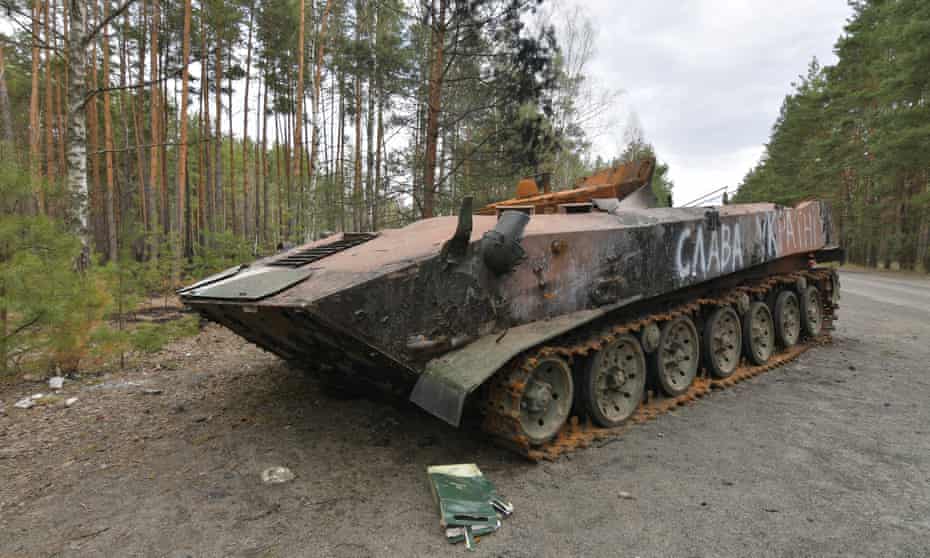 Burn-out Russian armoured vehicle with ‘Glory to Ukraine’ daubed on it