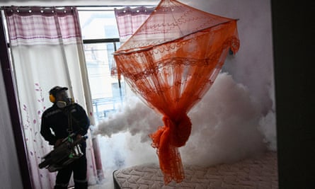 A worker fumigates a house against the Aedes aegypti mosquito to prevent the spread of dengue fever in a neighborhood in Piura, northern Peru, on 11 June 2023.