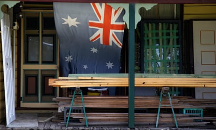 An Australian flag hangs on the front of a cottage in Muswellbrook.