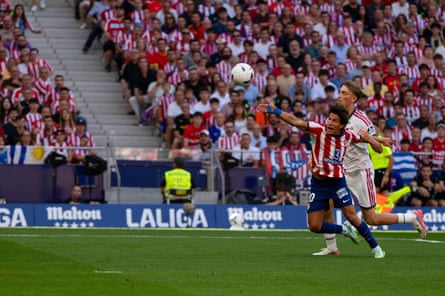 Real Madrid's Dean Huijsen fouls Giuliano Simeone