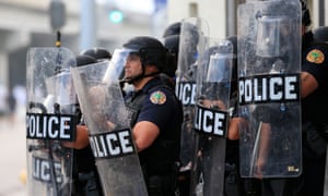 Police in riot gear use tear gas as they blockade the station’s parking garage as a rally in response to the police killing George Floyd on 30 May 2020 in Miami, Florida.