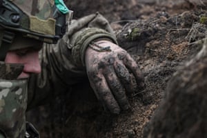 Ukrainian serviceman in a trench
