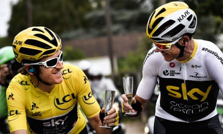 Geraint Thomas (left) clinks champagne glasses with Chris Froome as he approaches the finish of this year’s Tour de France.