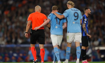 Erling Haaland consoles Kevin De Bruyne as the Belgian midfielder is forced off through injury.