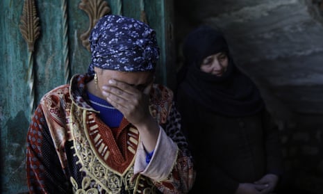 Relatives of abducted Coptic Christian Samuel Walham, weep outside their home in the village of el-Aour, south of Cairo