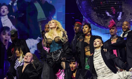 Madonna surrounded by performers on stage on the opening night of the Celebration tour.