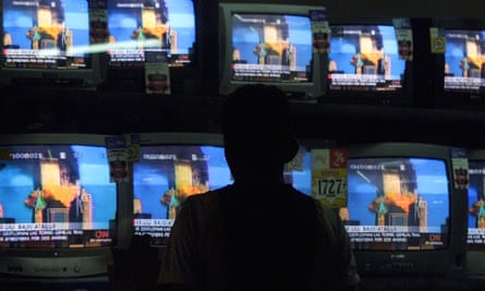 A man in Guatemala watches the destruction of the World Trade Center live on television.