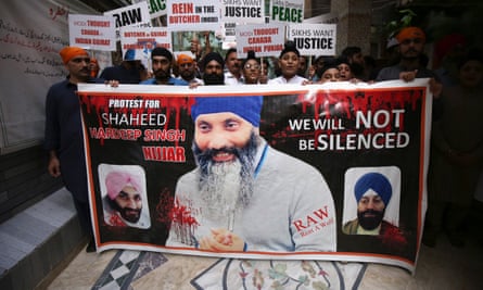 Pakistani Sikhs hold placards and a banner during a protest over the killing of Hardeep Singh Nijjar