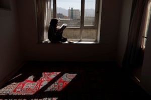 Hawa, 20, a third-year Russian literature student at the Burhanuddin Rabbani University (which was renamed by the Taliban to Kabul Education University), reads a book as she sits on a windowsill at her home in Kabul. Like hundreds of thousands of other Afghan girls and young women, Hawa has not been allowed to return to her studies since the Taliban seized power in mid-August. “We are not born to sit at home,” she told Reuters “If we can nurture babies we can provide for our families too. In this situation, I do not see my dreams coming true.”