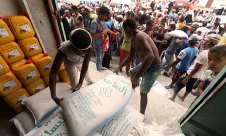 Workers unload sacks at aid distribution centre