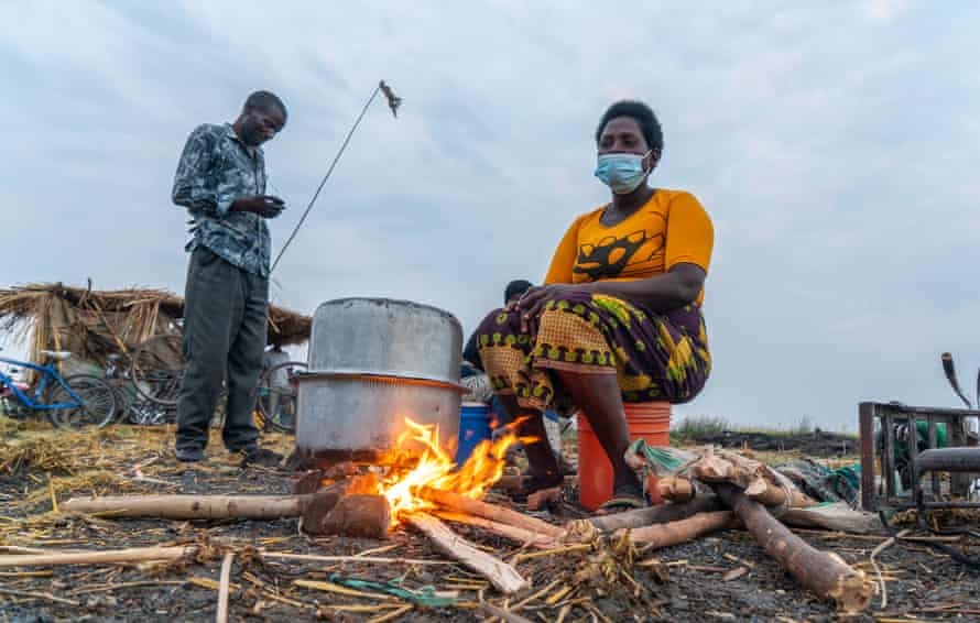 Belita Fenek prepares rice porridge over an open fire, Ntila market, Lake Chilwa