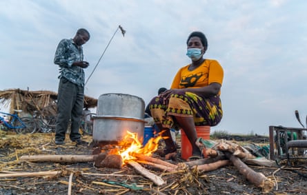 Belita Fenek prepares rice porridge over an open fire, Ntila market, Lake Chilwa