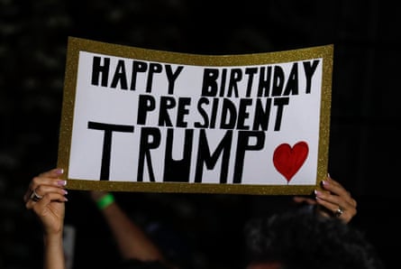A supporter raises a birthday sign during Trump’s speech at Trump National Golf Club, in Bedminster.