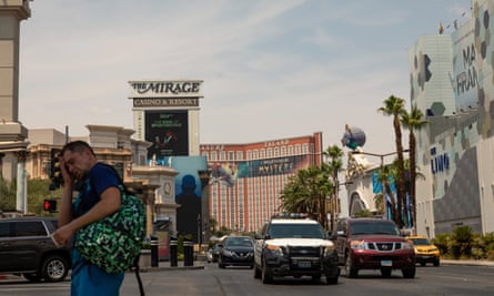 A man struggles to cross the street as the temperatures reach 116F on the strip.