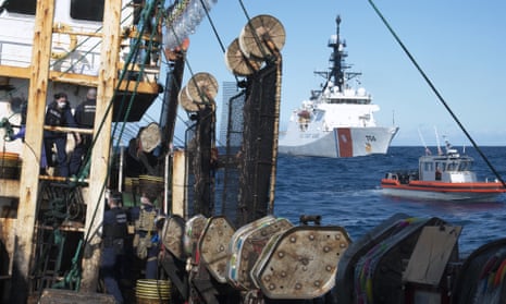 Guardsmen from the US Coastguard cutter James, right, search a fishing vessel in the eastern Pacific Ocean, August 2022. 