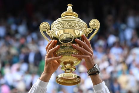 Novak Djokovic raises the winner’s trophy.