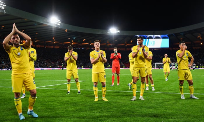 Ukraine's players salute their fans at the end of the match.