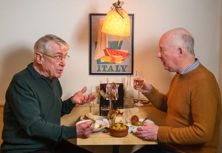 Two men facing each other across a restaurant table