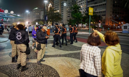 Police patrol on the Copacabana promenade in Rio de Janeiro.