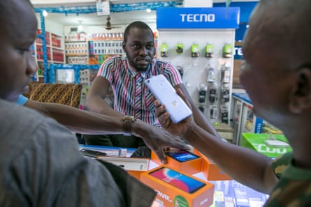 A worker inspects a Tecno phone
