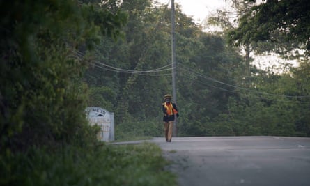Derrick ‘Black X’ Robinson walking along a tree-lined road on his annual walk to the Tacky memorial stone
