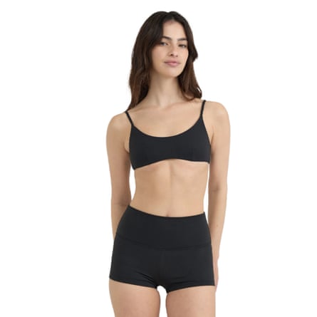 A model wears Organic Basics recycled nylon bikini set in black