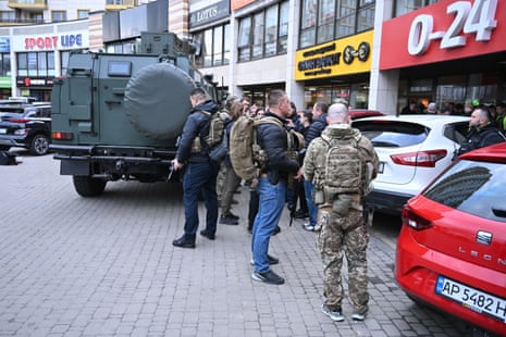 Armed officers gather outside a supermarket where a gunman took hostages in the Holosiivskyi district of Kyiv