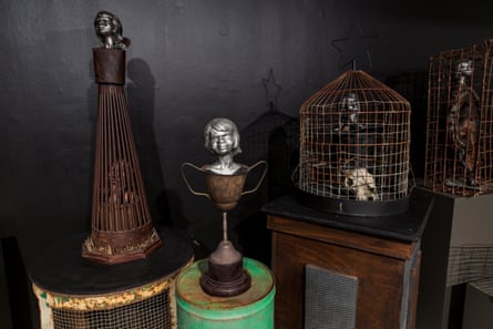 Dickens's sculptures of female figures in human animal cages.