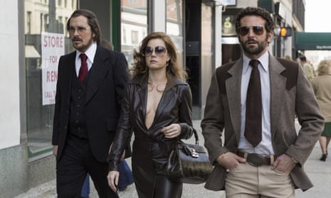 Pop-eyed tension and wacky hair … from left, Christian Bale, Amy Adams and Bradley Cooper in American Hustle. 