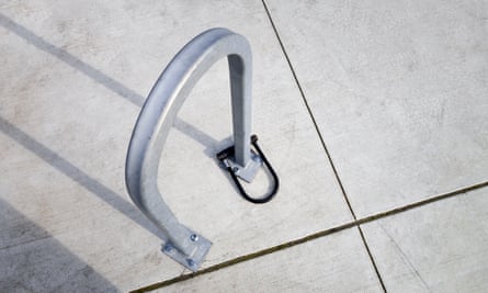 A bike lock attached to a bike railing. 