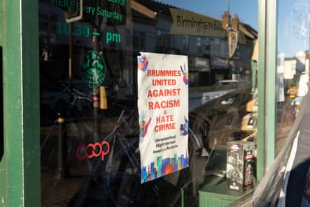 Sign in shop window says Brummies united against racism and hate crime.