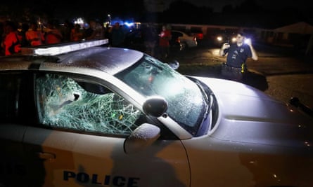 A Memphis police officer looks over a damaged squad car Wednesday in Memphis.