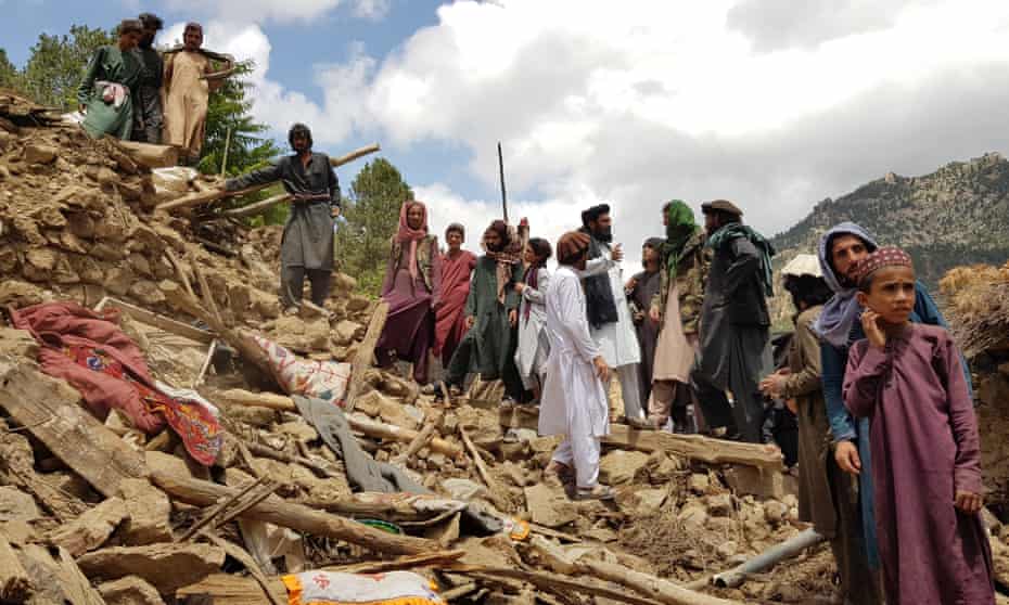 People search through rubble to find survivors of the earthquake in the Spera district of Khost province.