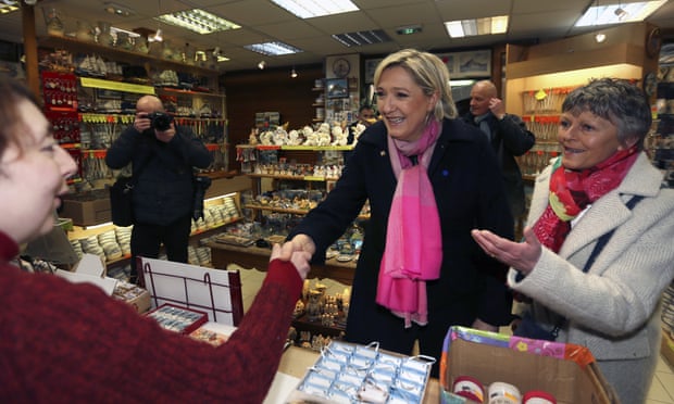 Marine Le Pen talks to shopkeepers during a visit in Le Mont Saint-Michel.