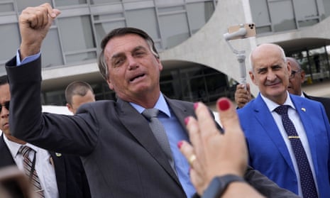 Jair Bolsonaro reacts to supporters outside the presidential palace in Brasília on Monday