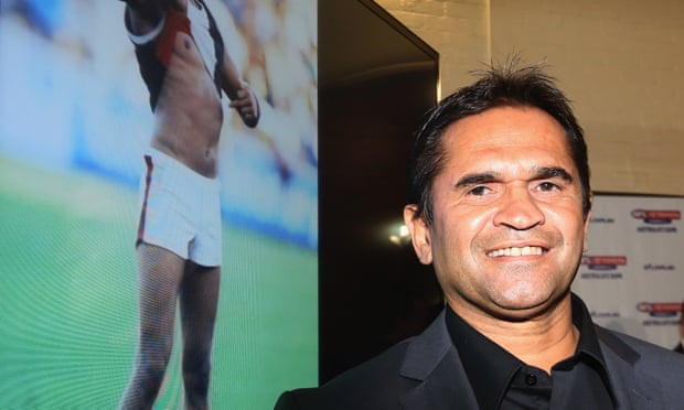 Nicky Winmar with the photograph of him lifting his shirt after receiving racist abuse. A statue of the moment will be unveiled in Perth next month