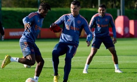 Cristiano Ronaldo (centre) challenges Fred during a Manchester United training session on Tuesday.