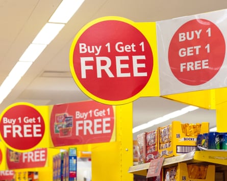 Supermarket shelves with signs saying ‘buy one get one free’