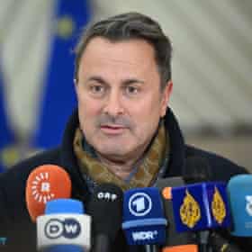 Luxembourg’s foreign minister Xavier Bettel with an array of media mics in foreground.