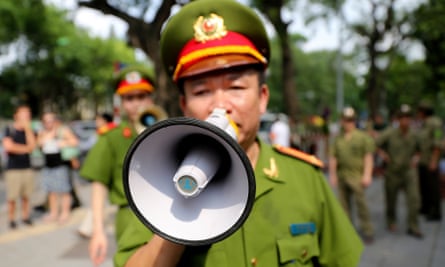 A Vietnamese police giving orders to pedestrians in Hanoi