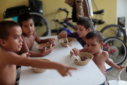 Honduran children eat at the Todo por Ellos immigrant shelter in Tapachula