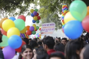 Gay rights activists and their supporters hold colorful balloons and placards as they participate in a gay pride parade in New Delhi