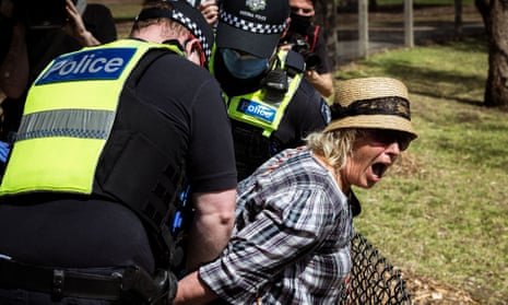 A woman is detained by Victoria police at Elsternwick Park in Melbourne, Australia