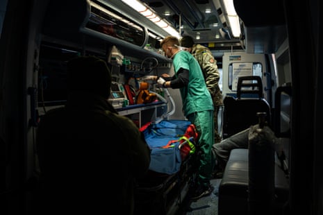 A doctor helps prepare an ambulance in the city of Konstantinivka.
