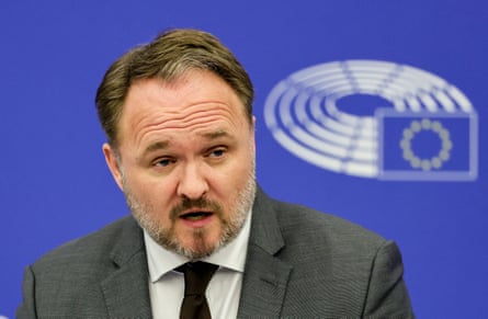 Head and shoulders of man in suit with beard