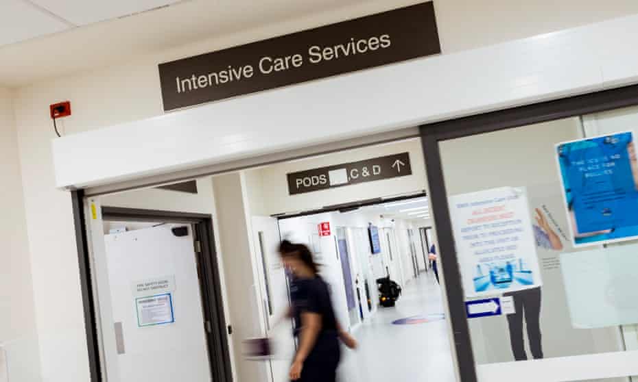 healthcare staff walk through a corridor at a hospital